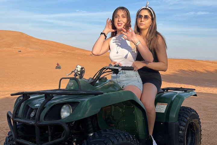 Experience the thrill of quad biking across golden dunes capturing unforgettable moments with friends against the breathtaking backdrop of Dubai's desert landscape. Adventure awaits in every ride!